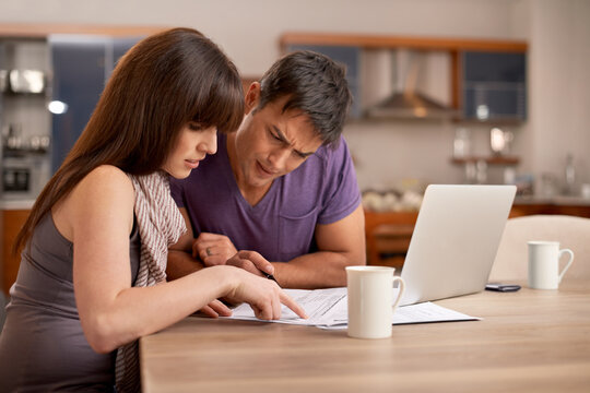 These Numbers Dont Look Right. Shot Of A Young Couple Doing Their Finances At Home.