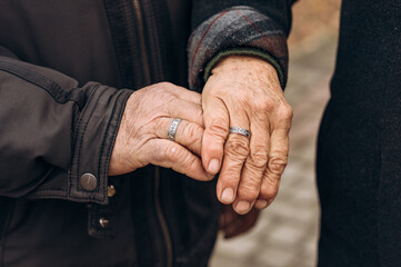 hands of old people with wedding rings eternal love hands with wrinkles
