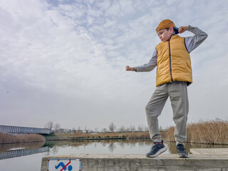 boy practices martial arts in the park