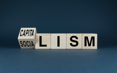 Capitalism or socialism. Cubes form the words capitalism or socialism. - obrazy, fototapety, plakaty