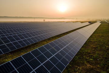 Aerial view of big sustainable electric power plant with many rows of solar photovoltaic panels for...