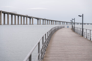 Obraz premium Girl sitting by the Tagus River in Lisbon, Portugal