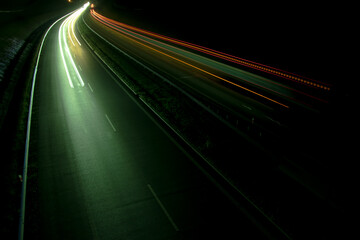 Night road lights. Lights of moving cars at night. long exposure red, blue, green, orange.