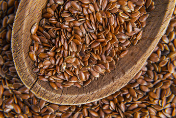 Wooden spoons with flaxseed close-up background pattern  Top view Flax seeds background or texture. flaxseed or linseed. Cereals. Healthy food. top view. High quality photo
