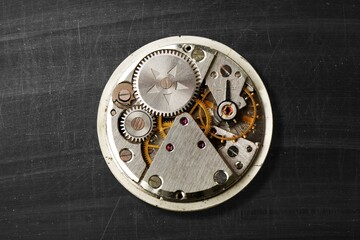 Vintage swiss clockwork mechanism. Pocket watch on background