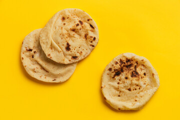 Egyptian bread Aish Baladi on. A lot of fresh bread lies on the yellow table
