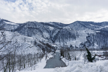 Winter mountain landscape with river view, cold