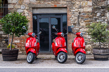 red scooter in front of a church