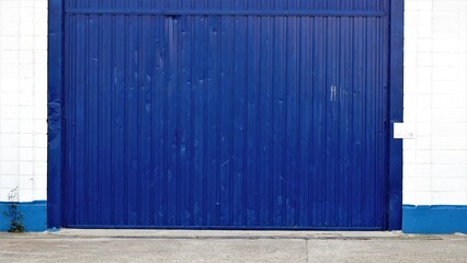 Naklejka na ściany i meble warehouse metal industrial blue door entrance