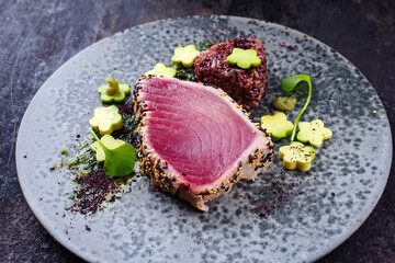 Modern style traditional Japanese gourmet seared tuna fish steak tataki with Sakura avocado,...