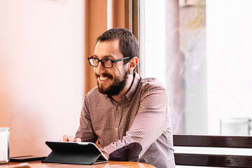 young businessman working on his tablet in a cafe shop