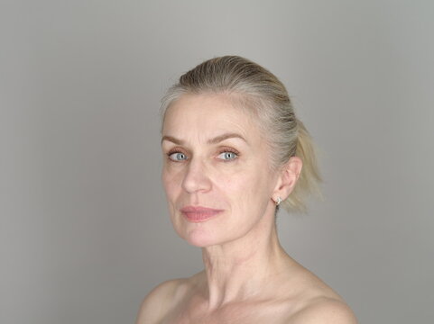 Confident adult model on gray