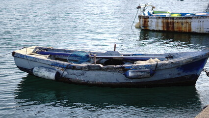 rustic fishing boat moored in the port