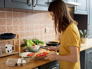 Young woman cooking at home