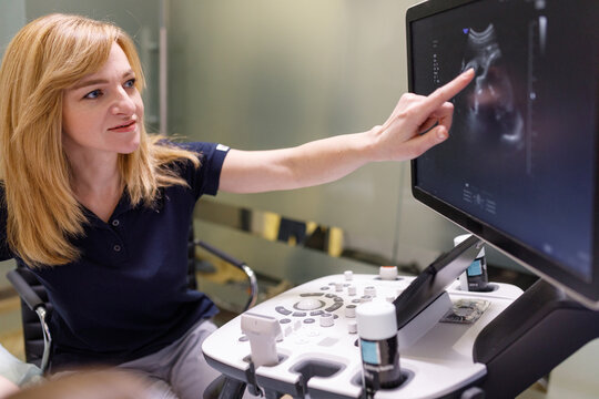 Specialist analyzing baby development during ultrasound