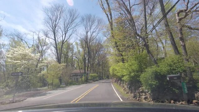driving in suburban road on a sunny spring day