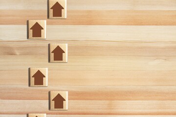 Chain of arrows wooden blocks. Consistency and focus. Concept of conformism, vertical of power.