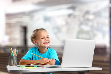 Distance education. Smiling child studying online at home,