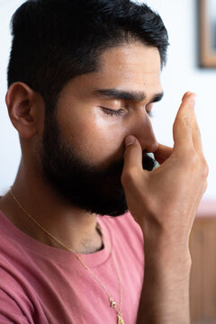 Man holding his nose during a pranayama breath practice