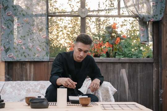 Young asian man dines noodles in a restaurant