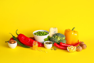 Set of healthy products with pills on color background