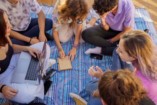 Friends planning trip on terace floor