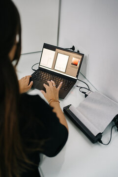 Woman typing on netbook at work