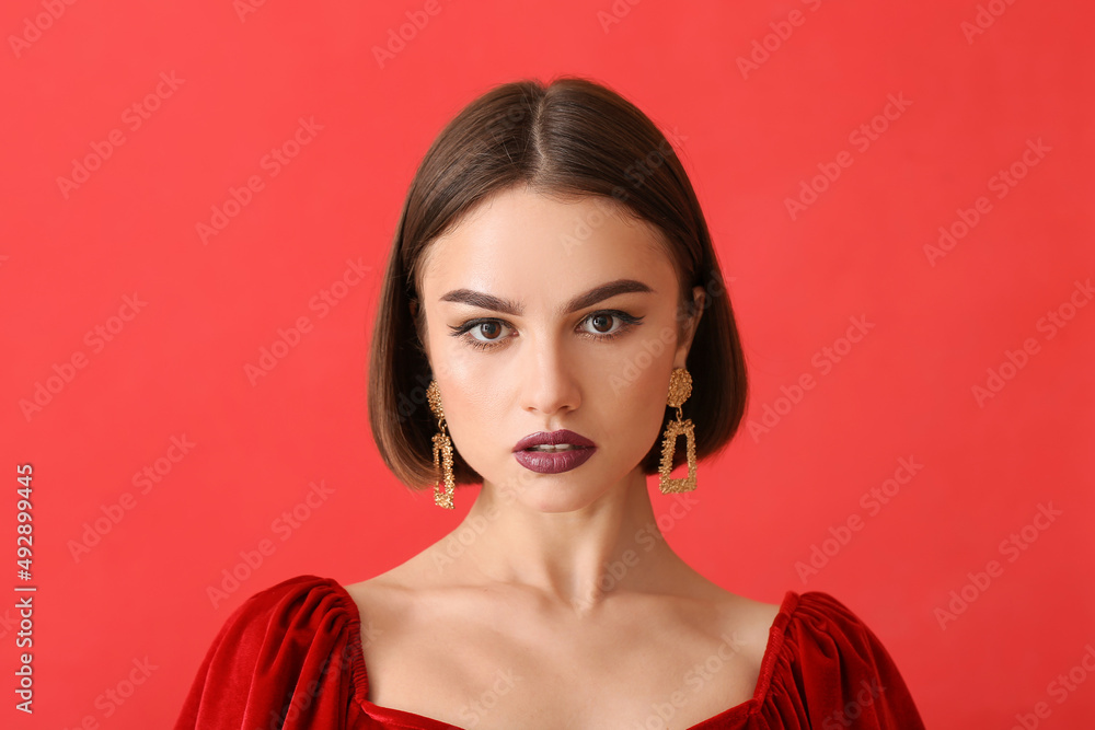 Canvas Prints Portrait of beautiful woman with dark lipstick and stylish jewelry on color background