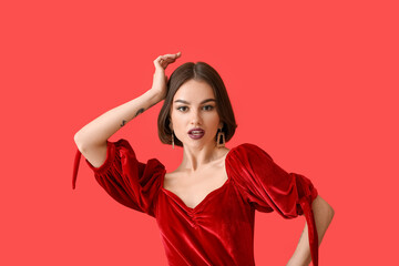 Fototapeta premium Beautiful woman with dark lipstick and stylish jewelry posing on color background