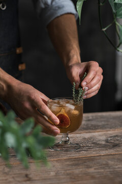 Mixologist Decorating Figs Drink With Fresh Thyme  