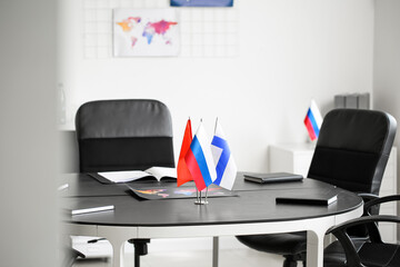 Different flags on dark table in office