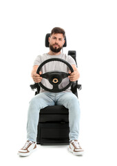 Handsome man with steering wheel in car seat on white background
