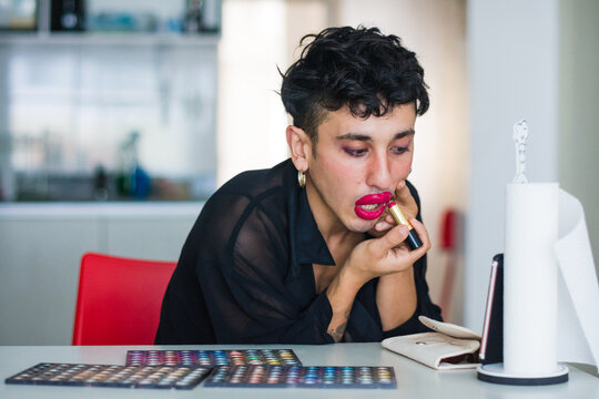 Latino non binary doing club kid make up