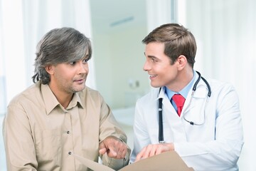 Doctor discussing treatment with cheerful smiley patient. Happy physician