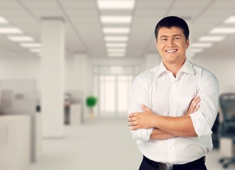 Proud and pleased man in casual wear stands with arms crossed