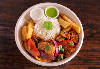 Peruvian chicken bowl with yucca fries and ricew