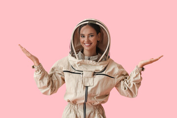Female beekeeper on color background