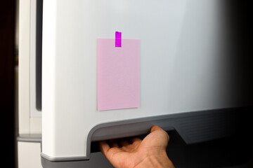 Pink note reminder paper sticked in freezer, fridge with glitter pink sticker. Refrigerator message