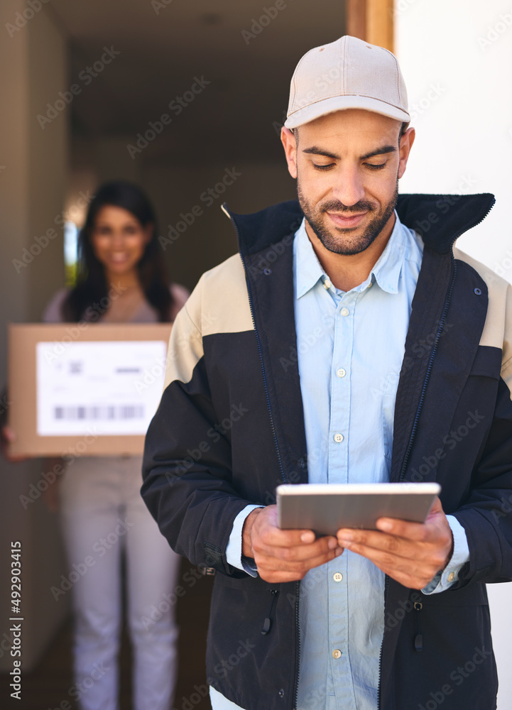 Poster we work with a completely digitized system. shot of a courier using a digital tablet while making a 