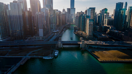 Chicago, IL USA- march 13th 2022: aerial drone shot of downtown Chicago by the river during early spring summer.  the beautiful skyscrapers look futuristic  along the green lake water
