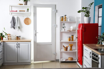 Red vintage fridge in interior of kitchen