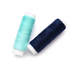 Different thread spools on white background