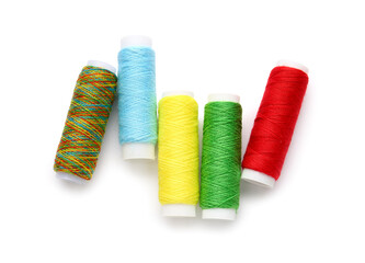 Different thread spools on white background