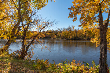 Beautiful fall colors adorn the Mississippi River in Minnesota as autumn brushes across the landscape in brilliant fashion waterway