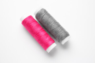 Different thread spools on white background
