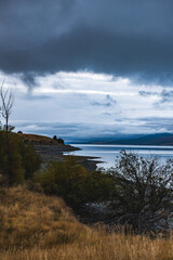 Grey clouds at mountain lake in New Zealand