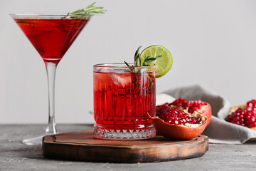 Glasses of tasty pomegranate cocktail on table