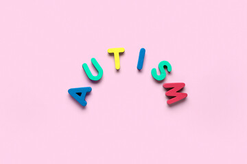 Colorful word AUTISM on pink background