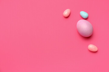 Painted Easter eggs on color background, top view