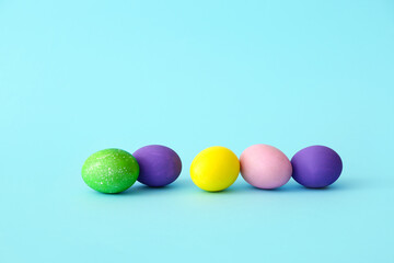 Painted eggs for easter celebration on color background